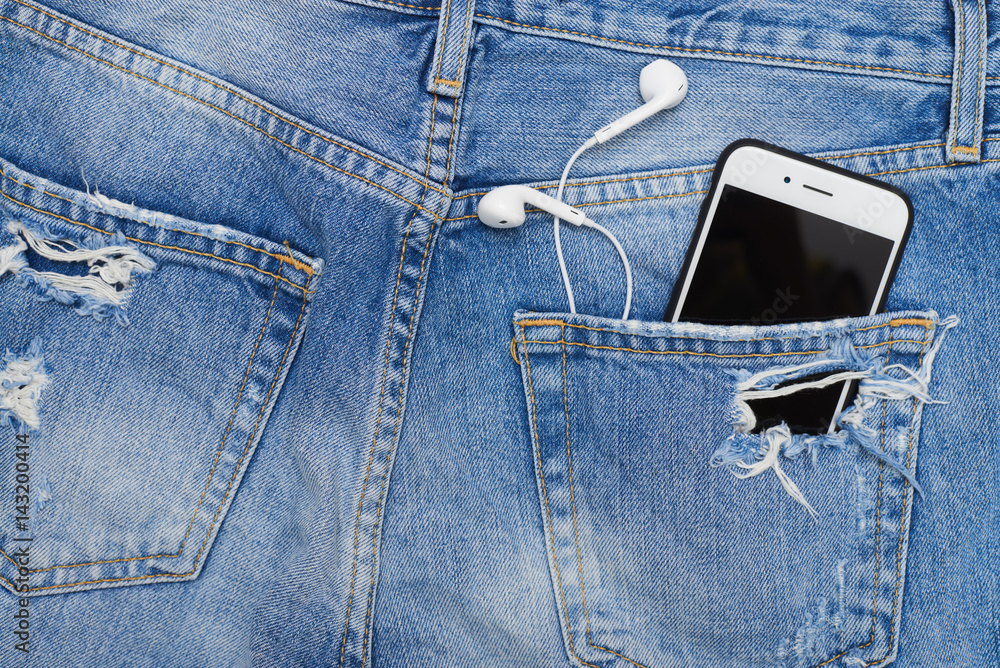 Overhead shot of pocket with telephone and headphones Overhead shot of pocket with telephone and headphones