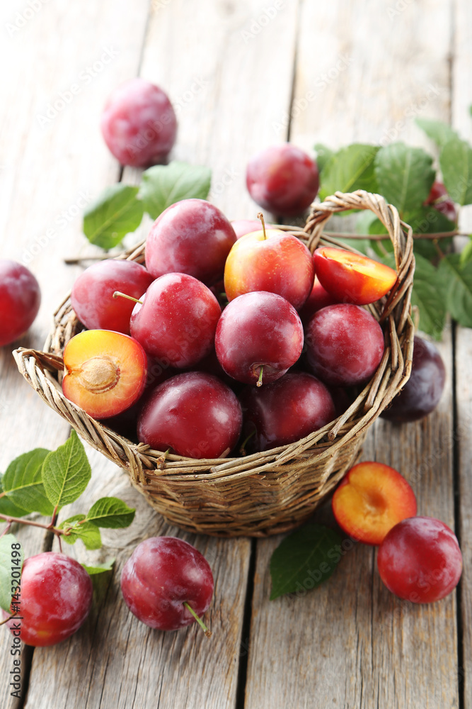 Fresh plums on a grey wooden table Fresh plums on a grey wooden table