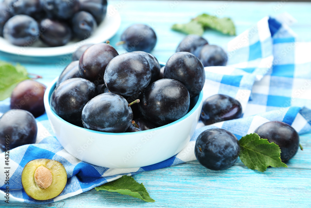 Tasty and ripe plums on blue wooden table Tasty and ripe plums on blue wooden table
