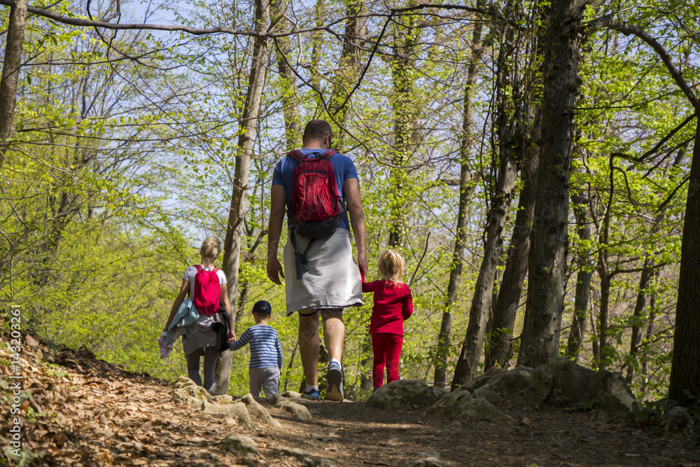 Fototapeta premium Parents with children walking by hiking trail