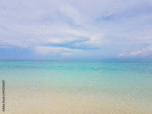 Sunshine on a sea wave at Karon beach, Phuket, Thailand. Sunny summer sea beach waves. Sunshine sea wave near sandy beach. Tropical island beach relax. Exotic landscape of ocean wave, Phuket island © tirachard
