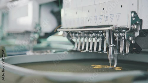 Embroidery needle, Needle with thread. Machine embroidery work.Machine embroidery is an embroidery process whereby a sewing machine or embroidery machine is used to create patterns on textiles. photo