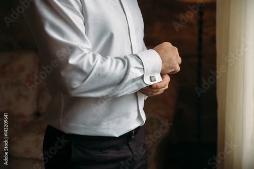 Gentlemans hands with cufflinks. Concept of business dress