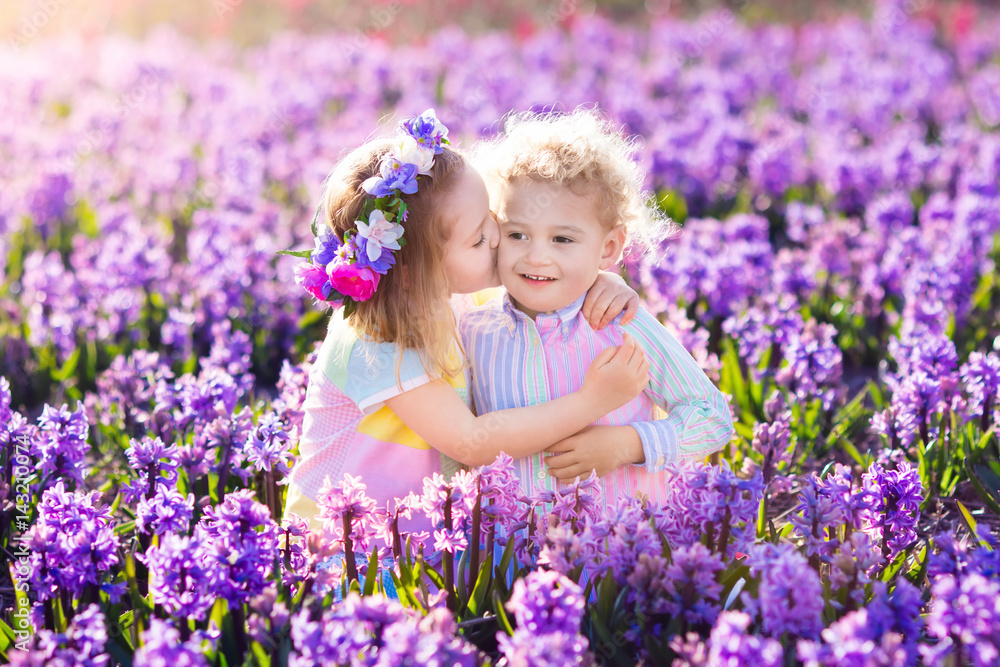 Kids playing in blooming garden with hyacinth flowers Kids playing in blooming garden with hyacinth flowers