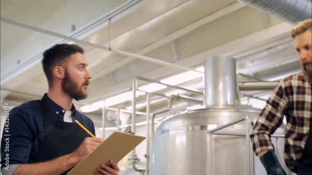 men with clipboard at brewery or beer plant men with clipboard at brewery or beer plant