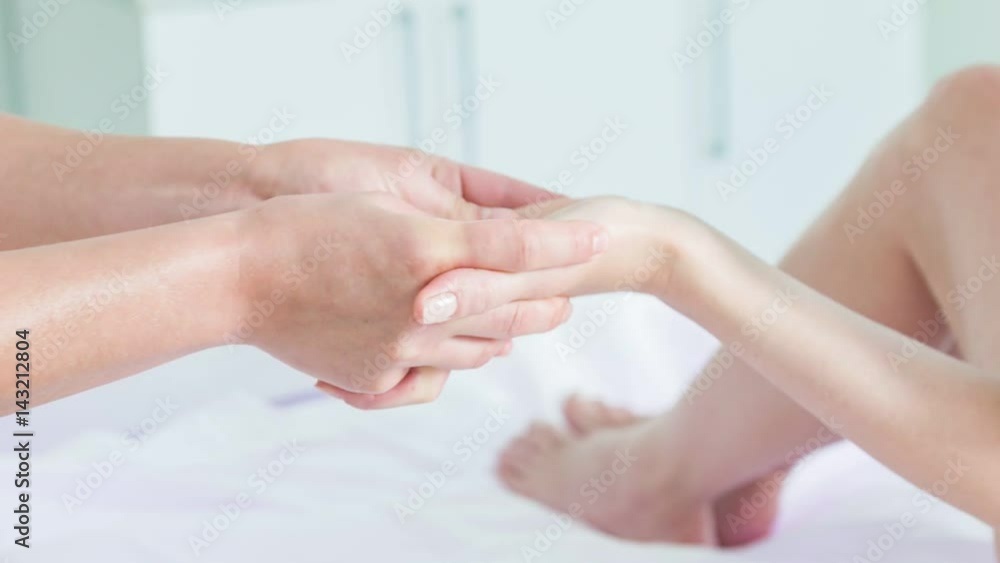 Professional masseuse massaging wrist of woman Professional masseuse massaging wrist of woman