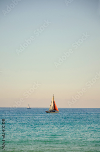 Lonely boat against the backdrop of the beautiful clear sea. Beautiful coast. An ideal place for rest and relaxation.
