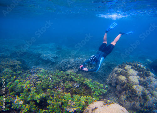 Snorkeling man in snorkeling mask. Photography underwater.