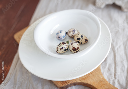 quail eggs on a white plate in the kitchen.