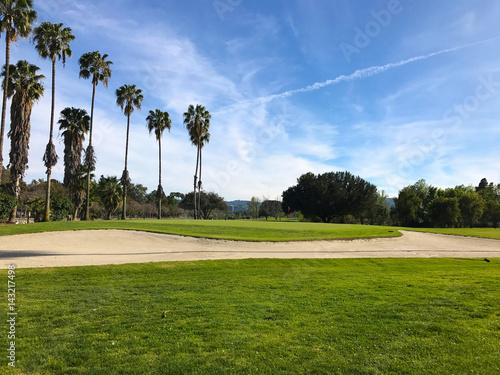 green golf field and blue cloudy sky. american landscape