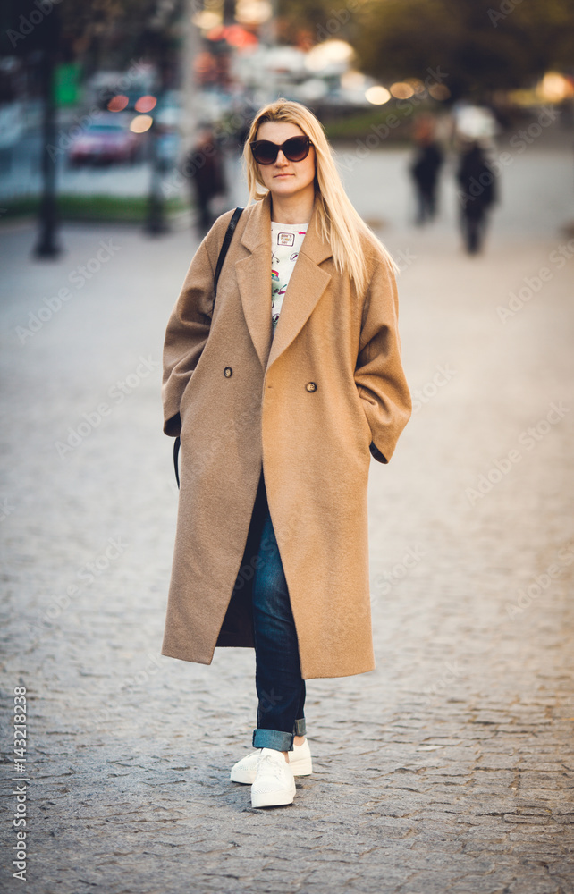 Young beautiful girl in coat walking Young beautiful girl in coat walking