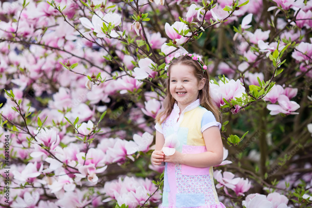 Child with magnolia flower. Little girl with flowers Child with magnolia flower. Little girl with flowers