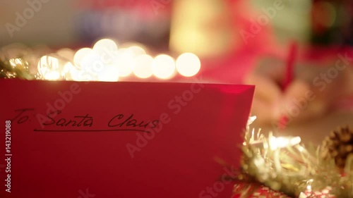 Writing a letter to Santa Claus on Christmas Eve photo