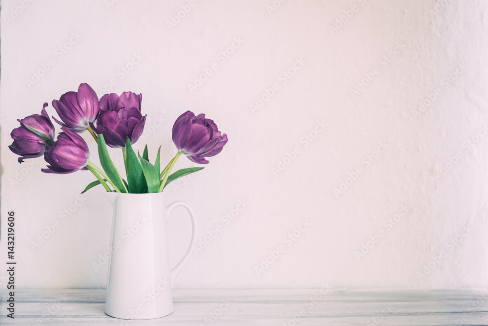Fresh pink tulip flowers bouquet on shelf in front of stone wall. View with copy space Fresh pink tulip flowers bouquet on shelf in front of stone wall. View with copy space