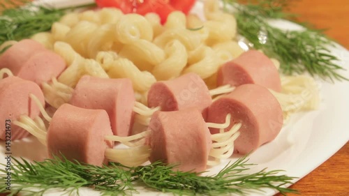 Pasta with sausages. Creative food art idea for children meal top view. photo