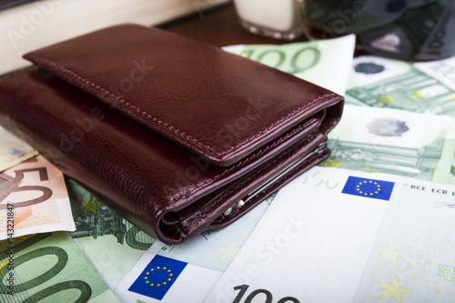 Closed leather men's wallet on the table