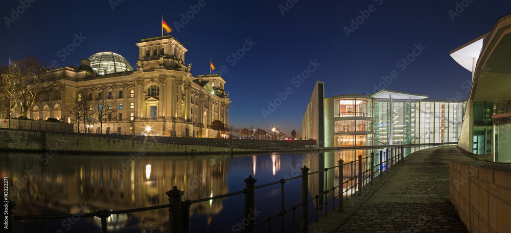 BERLIN, GERMANY, FEBRUARY - 16, 2017: Panorama of modern Government buildings and Reichstag over the Spree river in evening dusk.