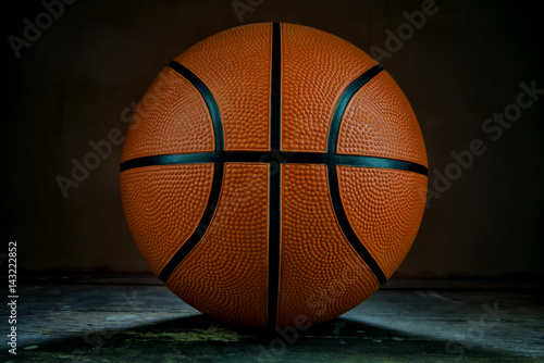 Basketball on the wood table and backlight.