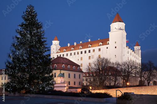 bratislava - castle from parliament at night and christmas tree and flags
