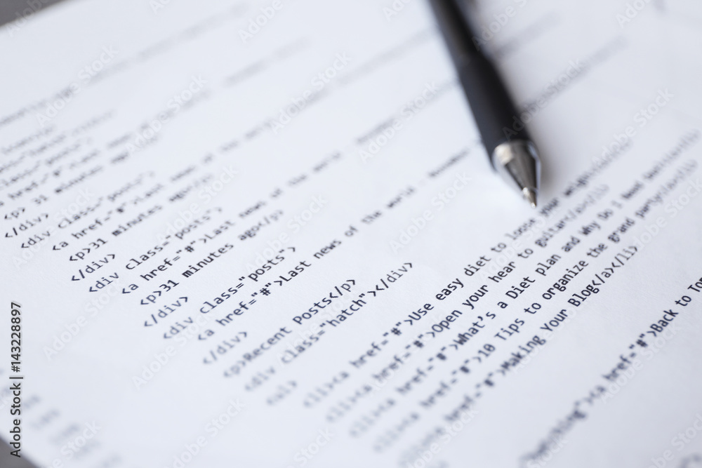 Script code on paper and pen, closeup. Software development concept Script code on paper and pen, closeup. Software development concept