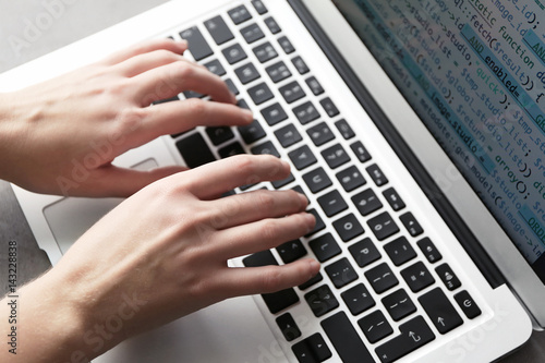 Programmer using laptop, cl...