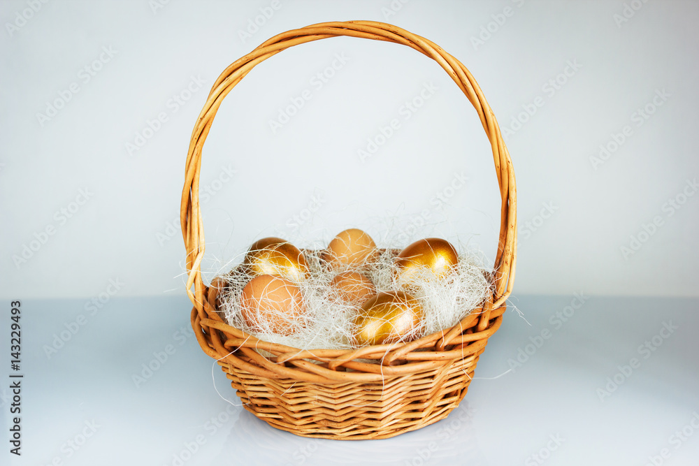 Easter golden eggs in a basket on table Easter golden eggs in a basket on table