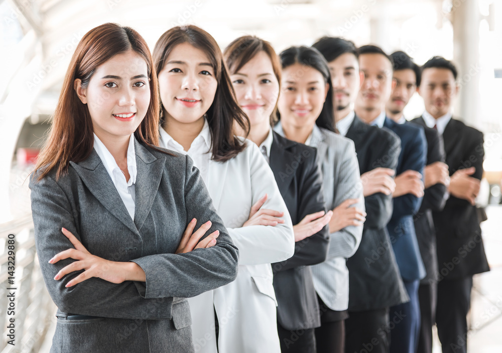 Happy smile Asian business team standing with cross arms in a row outdoor Happy smile Asian business team standing with cross arms in a row outdoor
