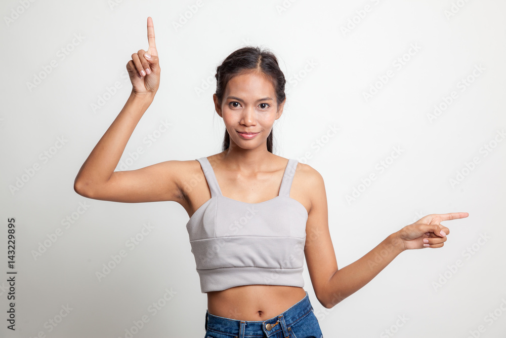 Young Asian woman point with two hands. Young Asian woman point with two hands.
