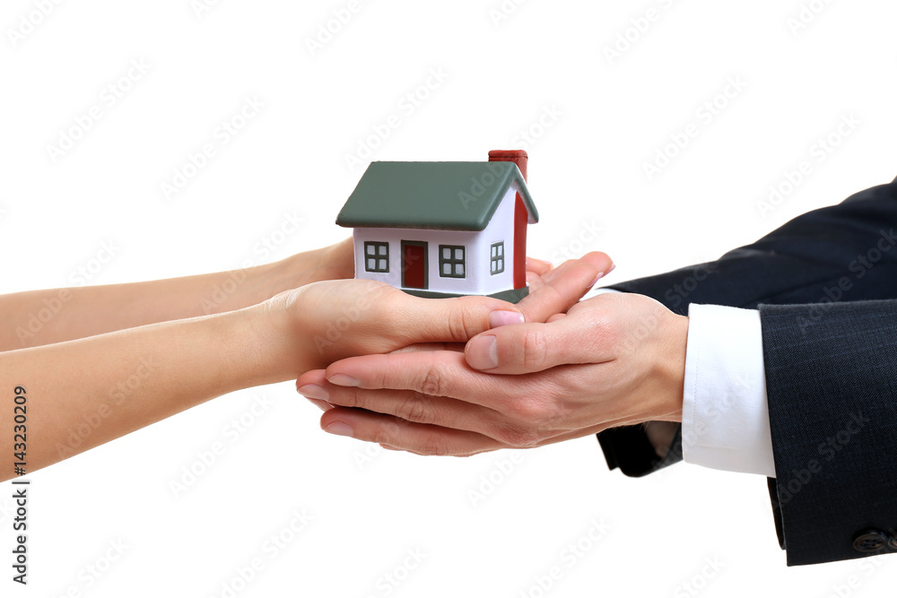 Naklejka premium People holding house model on white background