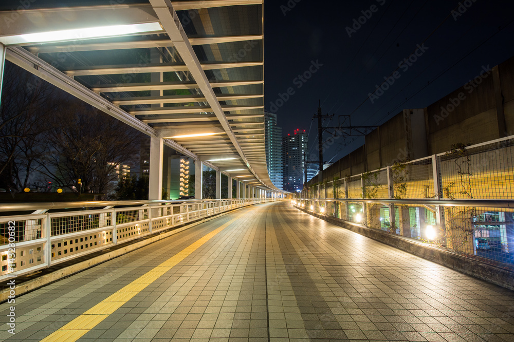 Covered pedestrian bridge at night, in Saitama, Japan.