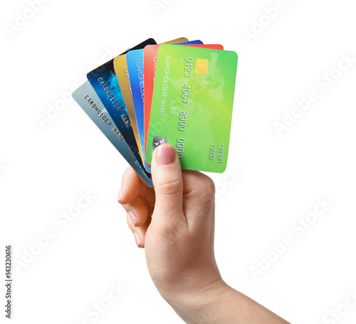 Female hand holding credit cards on white background