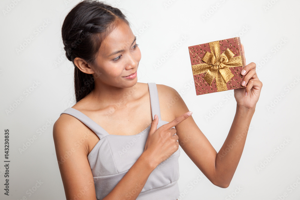Young Asian woman with a gift box. Young Asian woman with a gift box.