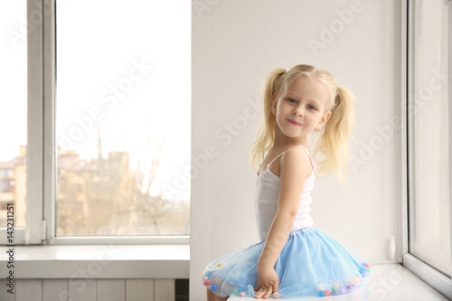 Cute little girl sitting on...