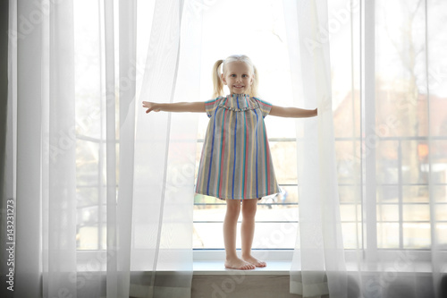 Cute little girl standing o...