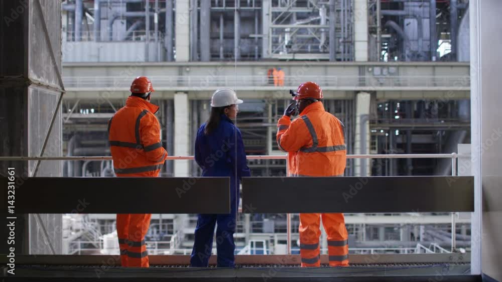 Male & female engineers conducting checks at power station Male & female engineers conducting checks at power station