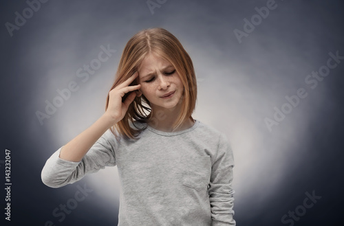 Cute girl suffering from he...