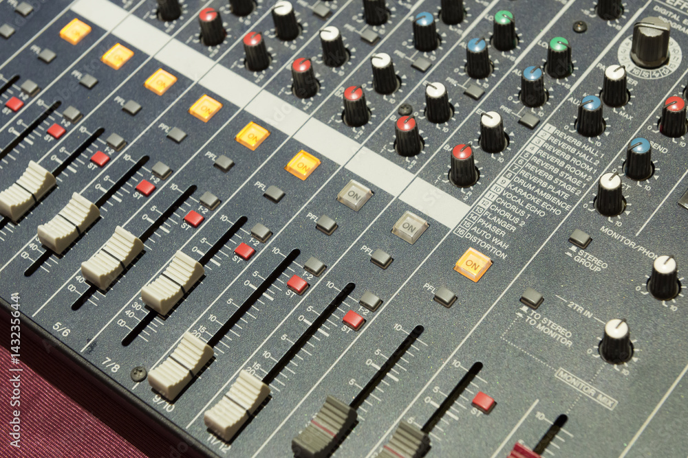 The mixer table or fader board for music production in light blue scene with the lighting effect