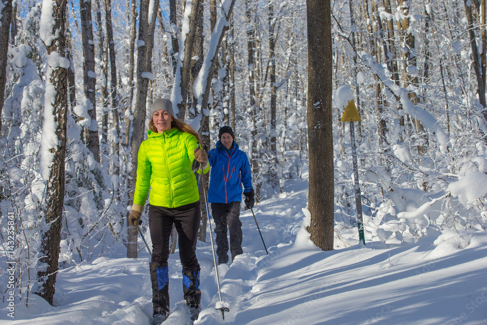 Couple cross country skiing in winter