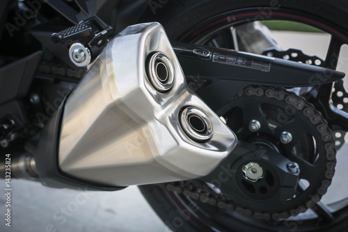 Close up of exhaust pipe motorcycle on the road.