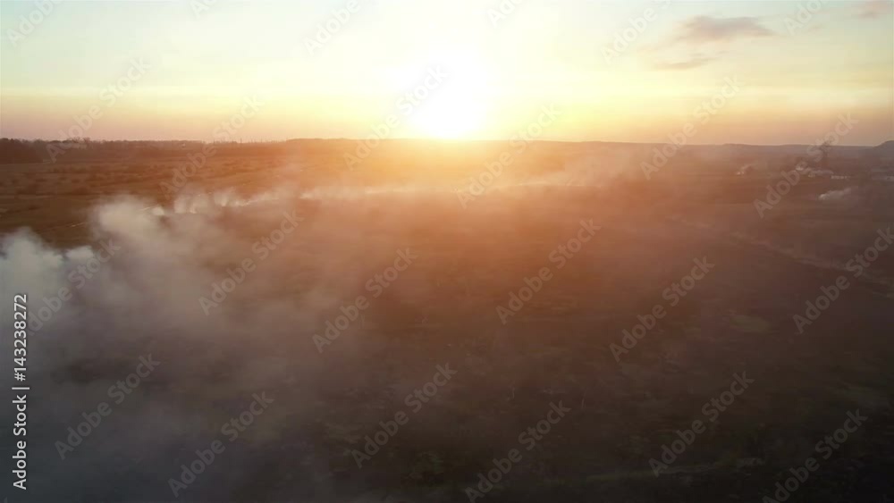 Aerial 4k. Fire fields at sunset. Large-scale fire, the view from the top. The camera flies through the thick smoke. Smog in a large area Aerial 4k. Fire fields at sunset. Large-scale fire, the view from the top. The camera flies through the thick smoke. Smog in a large area