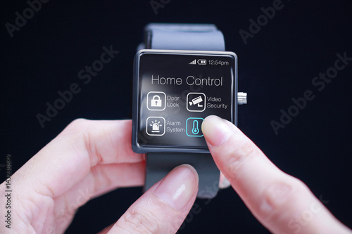 Hand touching home control application on smartwatch