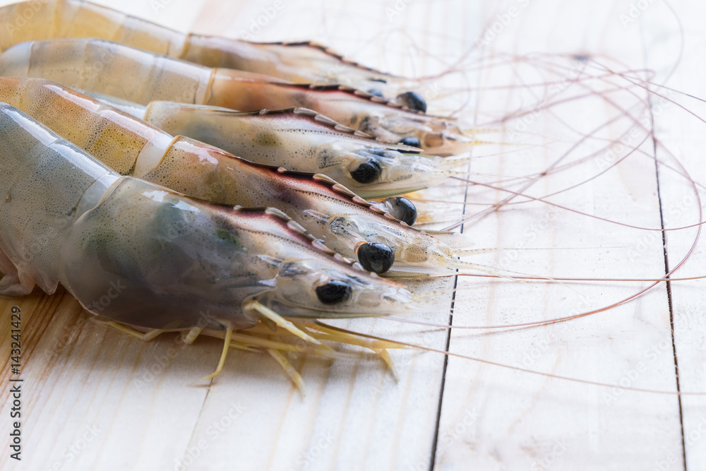 Fresh Whiteleg shrimp, pacific white shrimp on wooden Fresh Whiteleg shrimp, pacific white shrimp on wooden