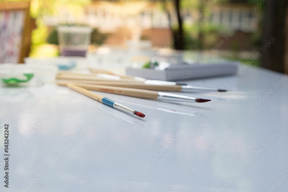 Fototapeta premium Used paint brush on white table.