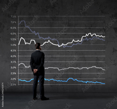 Businessman standing over diagram background. Business, finance, investment concept.