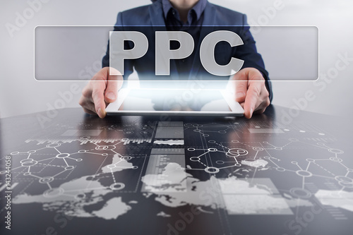 Businessman using tablet pc and selecting ppc . photo