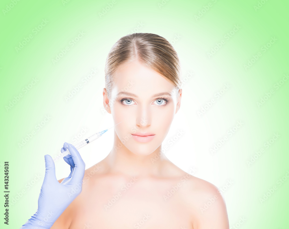 Young, beautiful and healthy woman having skin injections over green background. Plastic surgery concept. Young, beautiful and healthy woman having skin injections over green background. Plastic surgery concept.