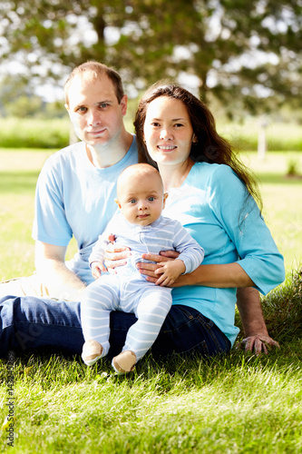 Smiling multiethnic family with newborn child