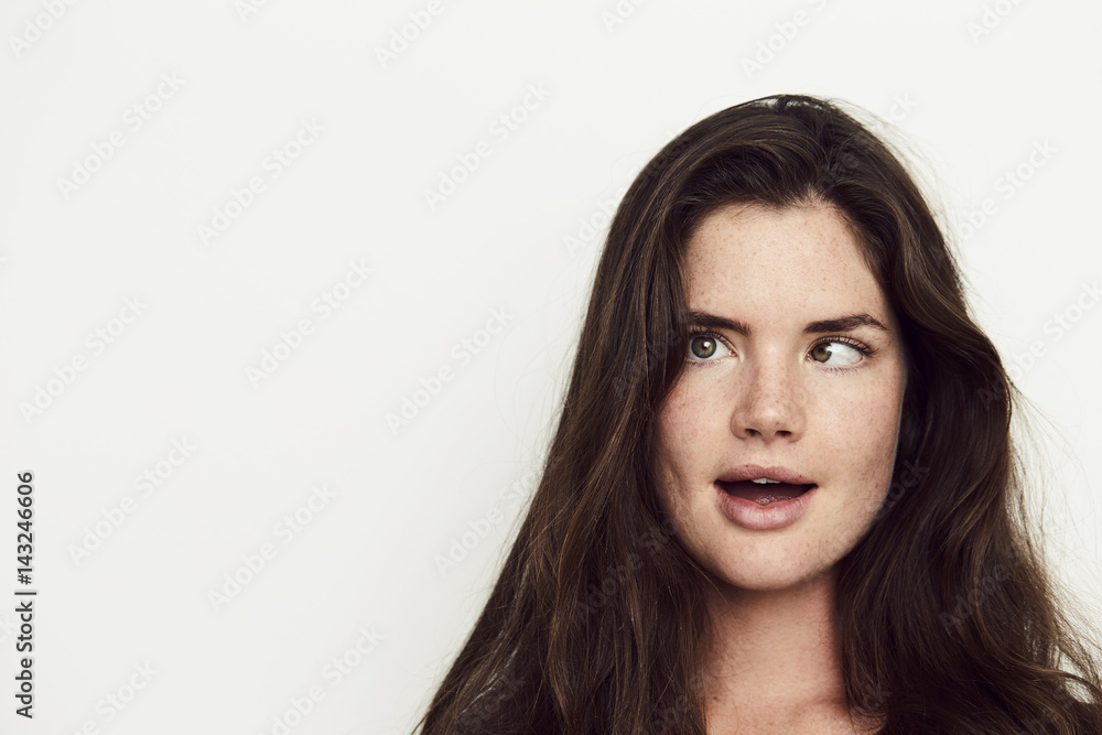 Girl with crossed eyes in white studio