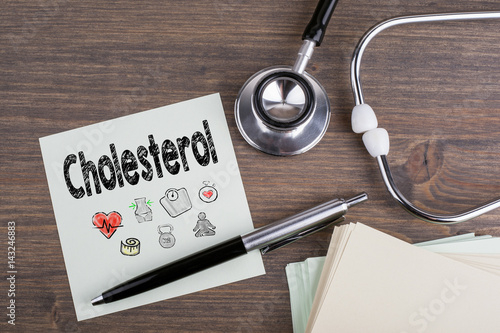 Cholesterol, Workplace of a doctor. Stethoscope on wooden desk background. photo