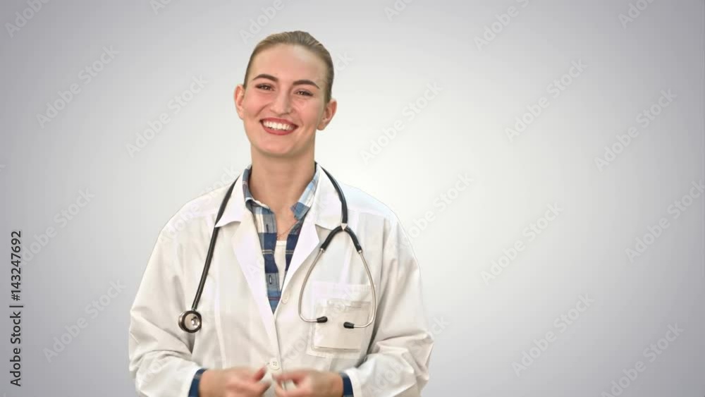 Smiling beautiful woman in lab coat talking to the camera on white background. Smiling beautiful woman in lab coat talking to the camera on white background.